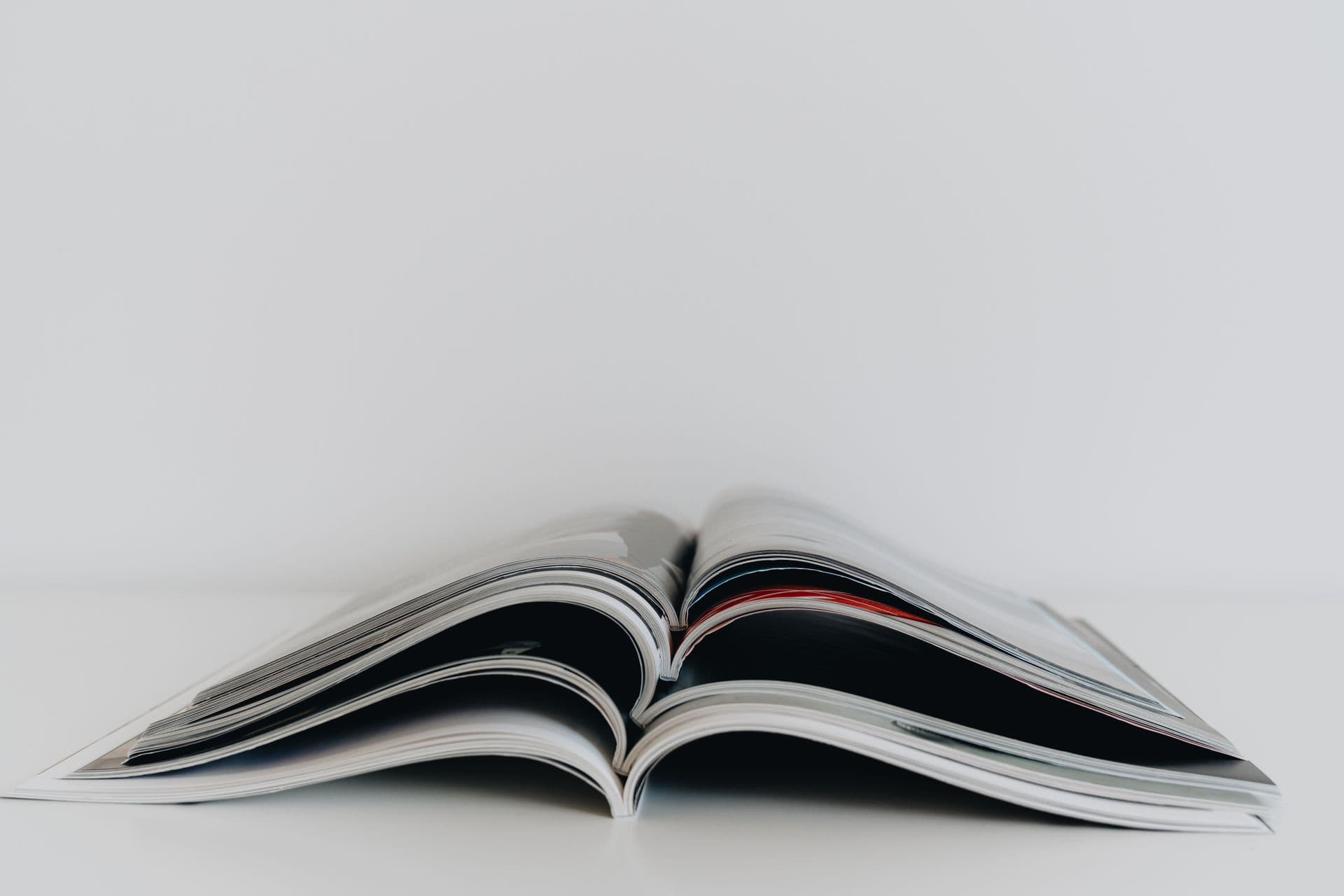 One open magazine resting on a white surface