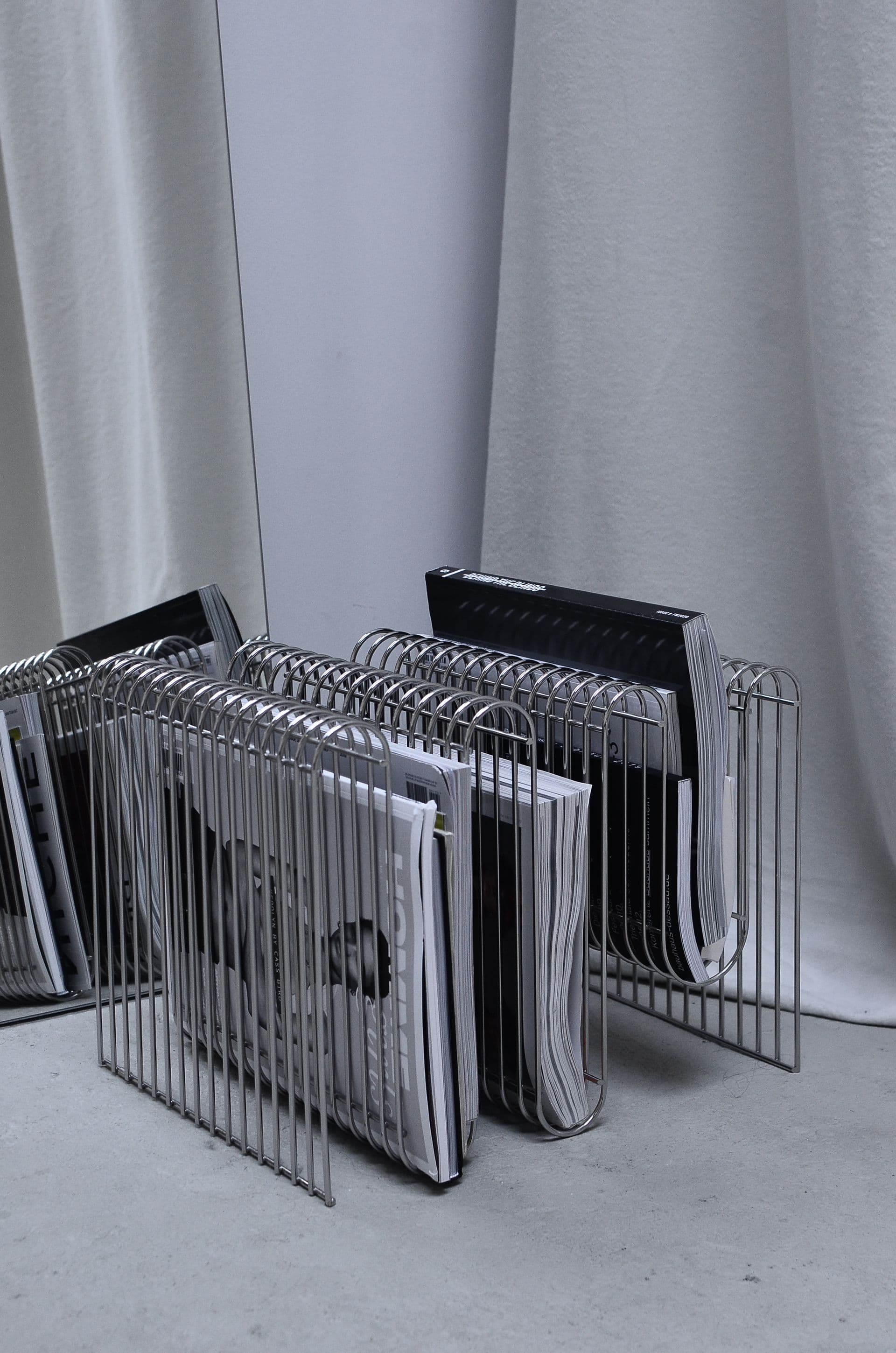 A wire rack holding a full run of magazines